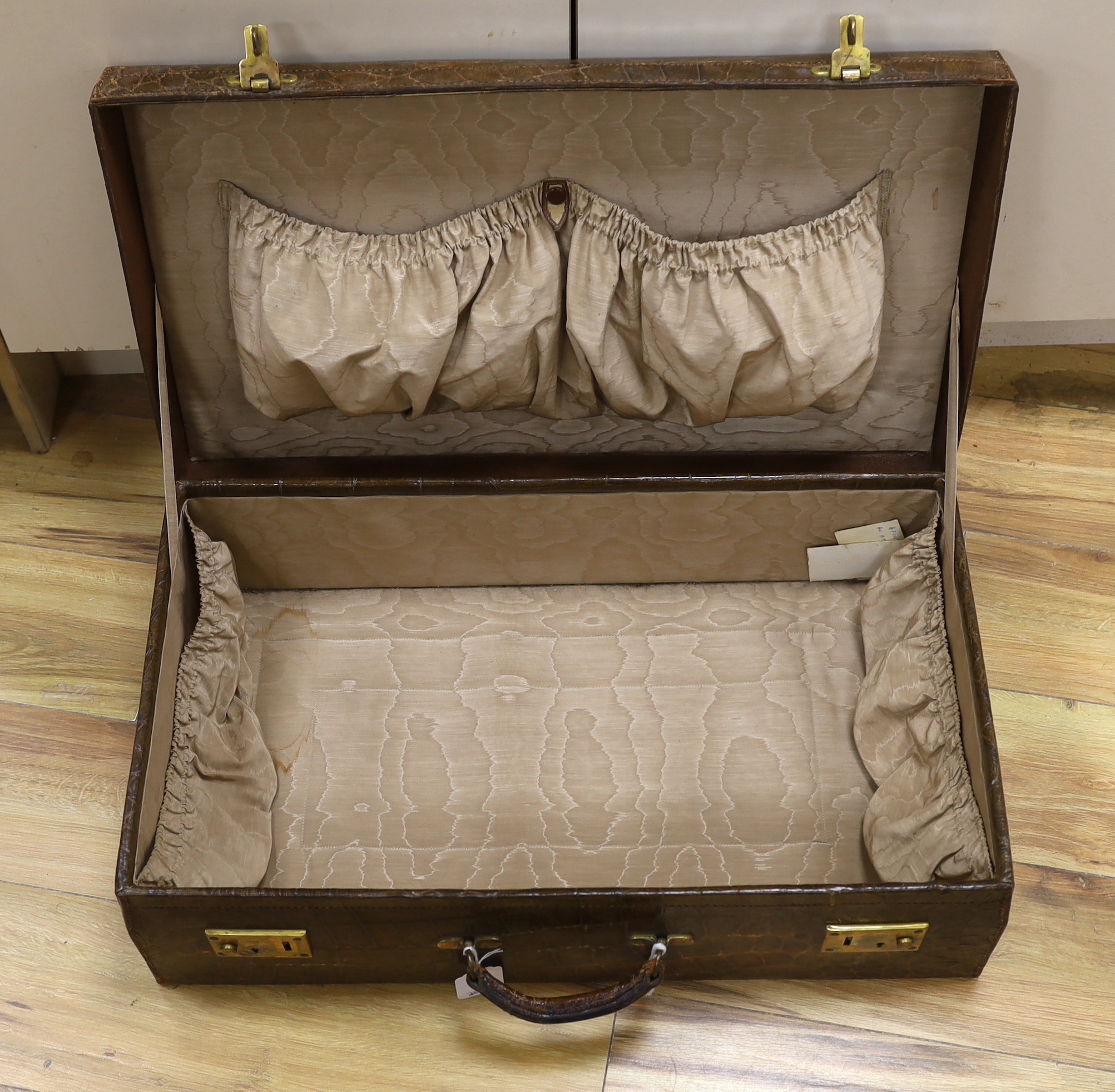 A Vintage 1930’s crocodile skin travelling case, 65cm wide